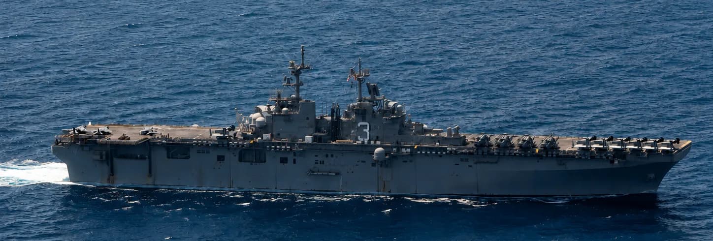 Container ship under naval escort in a high-risk shipping corridor